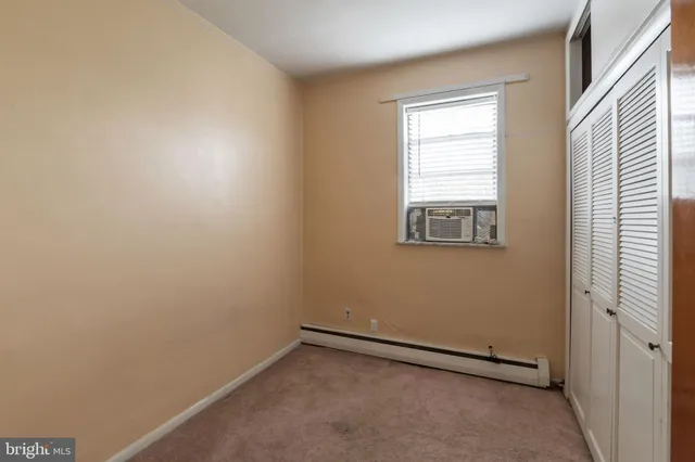 an empty room with closet area