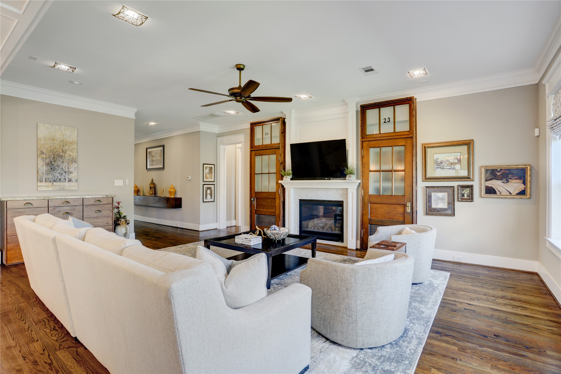 6430 Rolla Street Houston, TX 77055 - Photo 12 of 30 a living room with furniture a fireplace and a flat screen tv