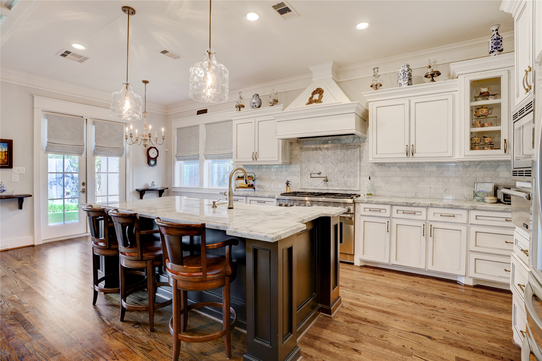 6430 Rolla Street Houston, TX 77055 - Photo 13 of 30 a kitchen with a stove a sink a dining table and chairs