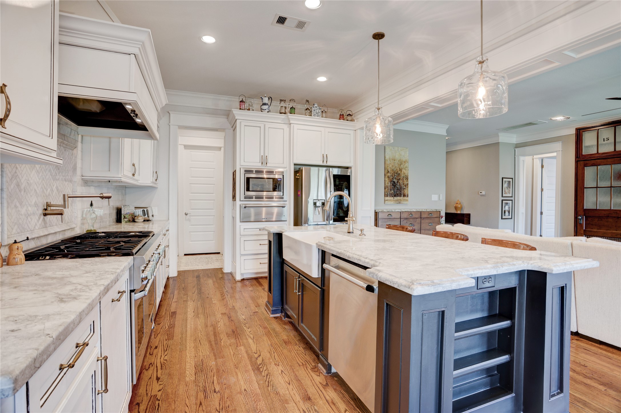 6430 Rolla Street Houston, TX 77055 - Photo 15 of 30 a large kitchen with stainless steel appliances a stove a sink dishwasher and a refrigerator with wooden floor