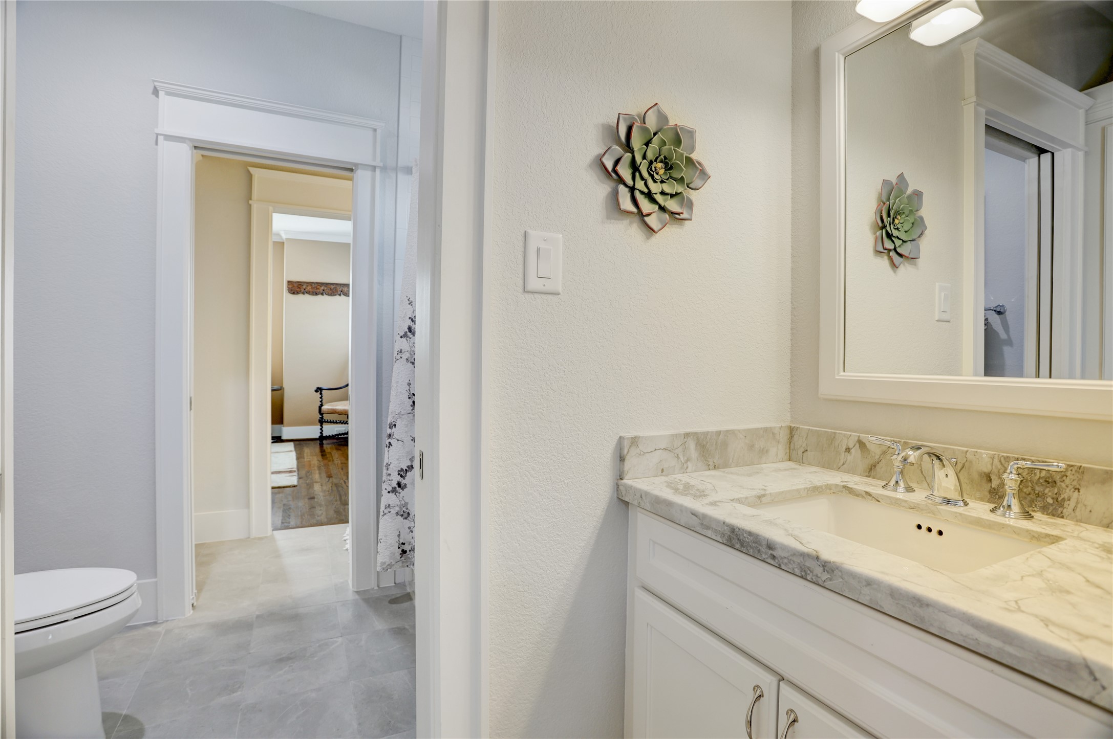 6430 Rolla Street Houston, TX 77055 - Photo 26 of 30 a bathroom with a granite countertop sink a toilet and a mirror
