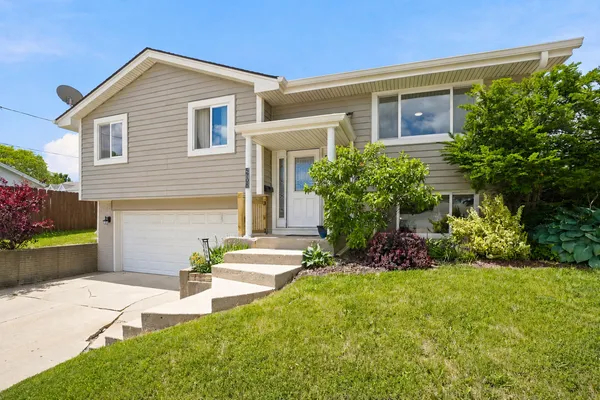 a front view of a house with a yard and outdoor seating
