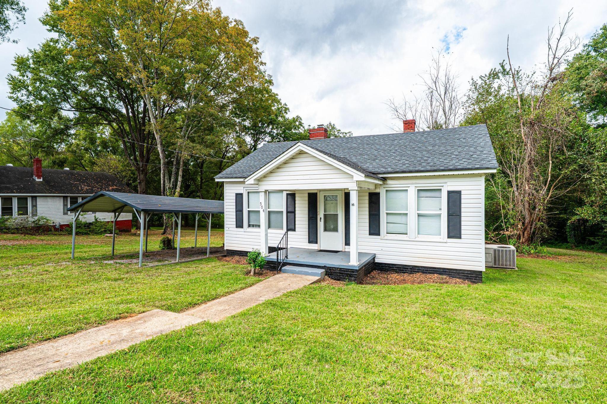 a front view of a house with a yard table and chairs