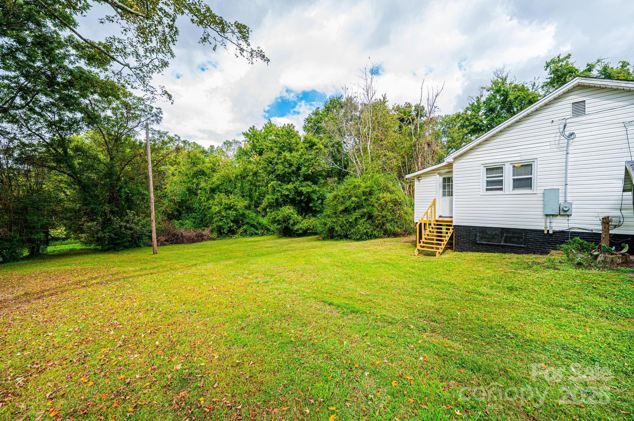 504 North Spring Avenue Newton, NC 28658 - Photo 13 of 35 a view of a house with a backyard