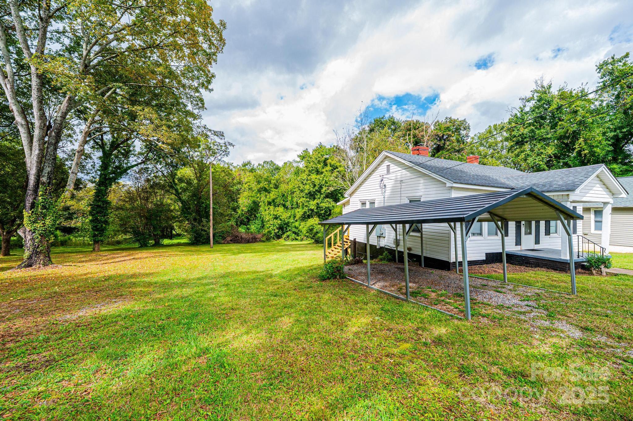 504 North Spring Avenue Newton, NC 28658 - Photo 14 of 35 a house that has a big yard with wooden fence