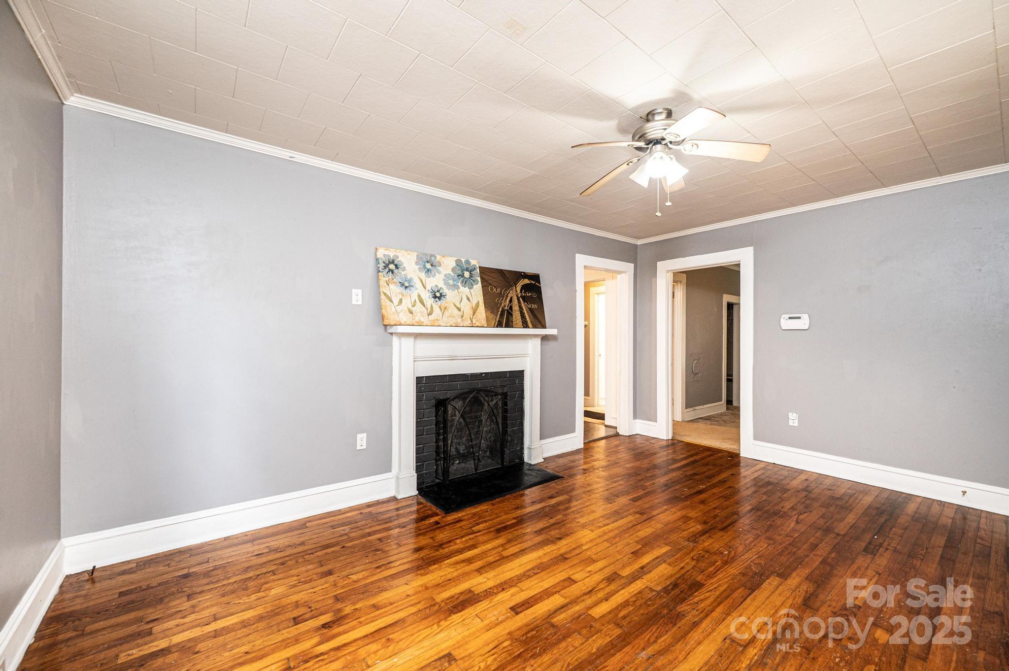504 North Spring Avenue Newton, NC 28658 - Photo 16 of 35 a view of an empty room with wooden floor and a fireplace