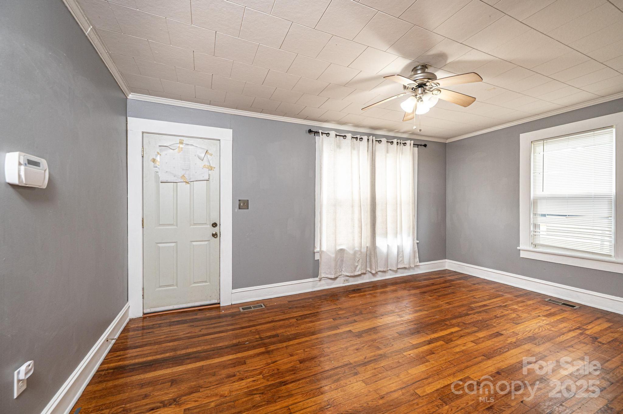 504 North Spring Avenue Newton, NC 28658 - Photo 18 of 35 a view of an empty room with wooden floor and a window