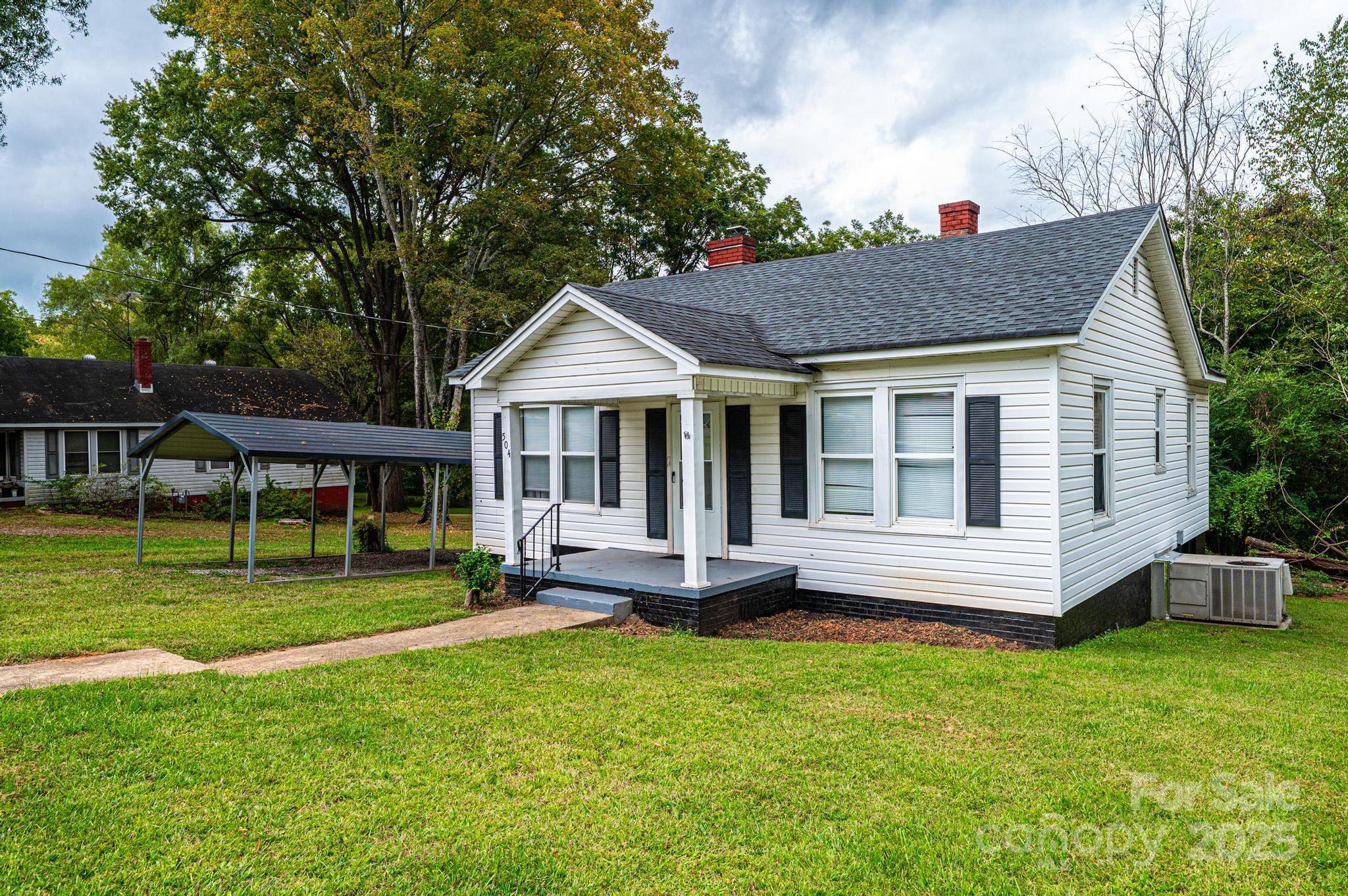504 North Spring Avenue Newton, NC 28658 - Photo 2 of 35 a front view of a house with a yard table and chairs