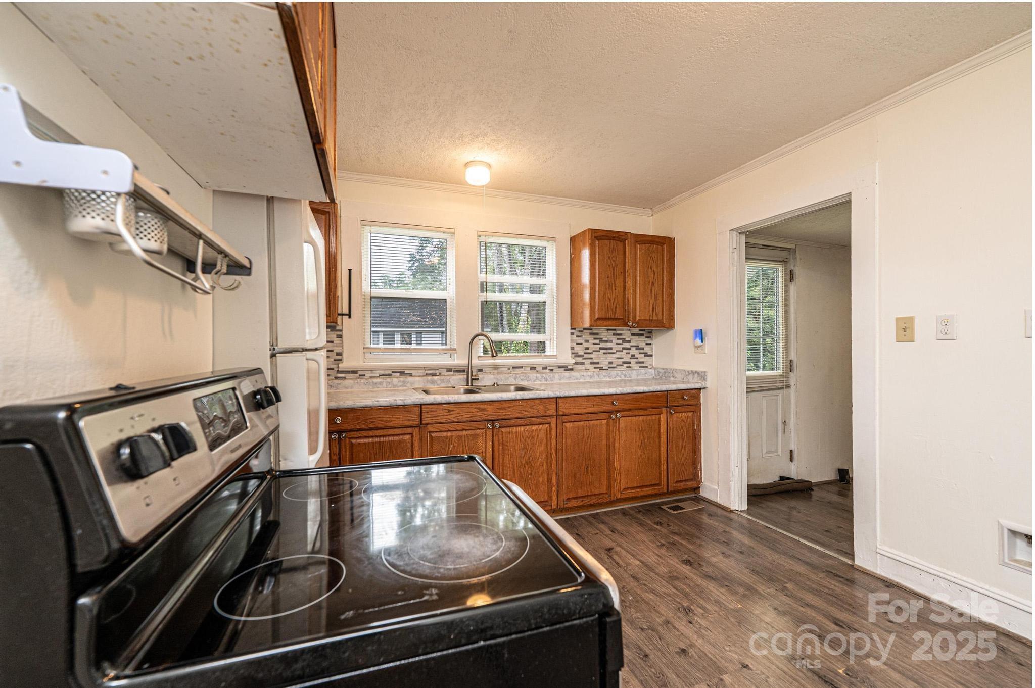 504 North Spring Avenue Newton, NC 28658 - Photo 22 of 35 a kitchen with stainless steel appliances granite countertop a stove and a sink
