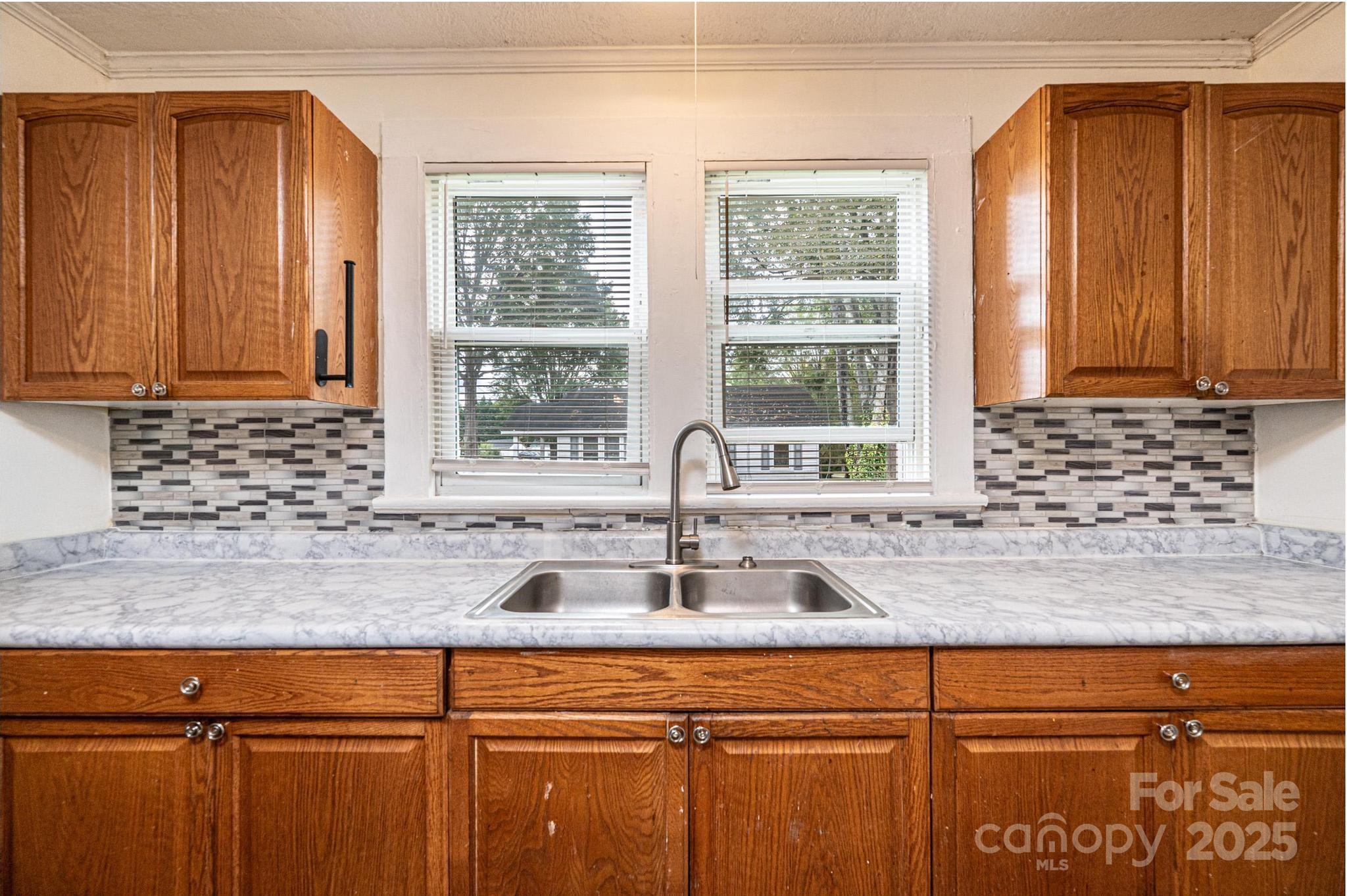 504 North Spring Avenue Newton, NC 28658 - Photo 23 of 35 a kitchen with granite countertop a sink and cabinets
