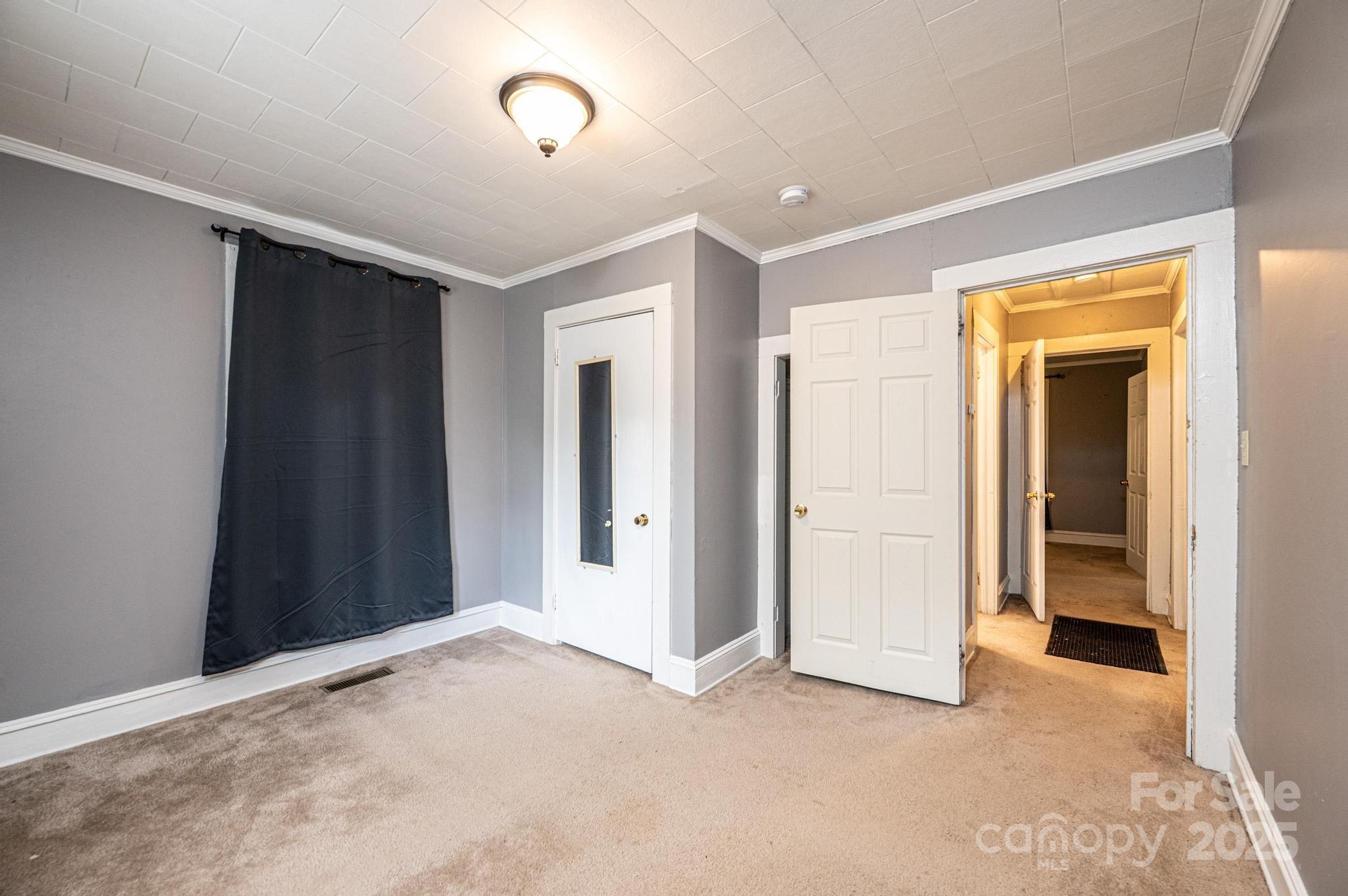 504 North Spring Avenue Newton, NC 28658 - Photo 25 of 35 an empty room with closet and a bathroom
