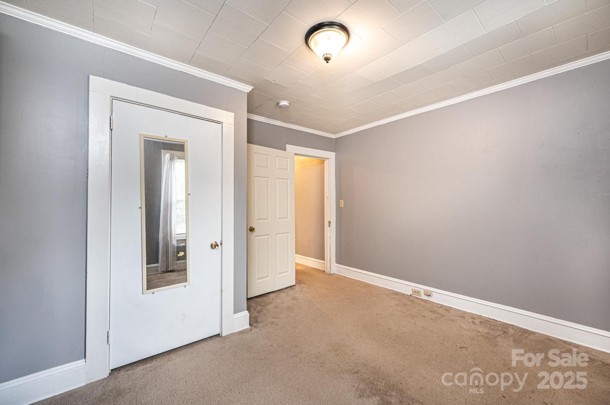 504 North Spring Avenue Newton, NC 28658 - Photo 27 of 35 an empty room with a bathroom and a mirror