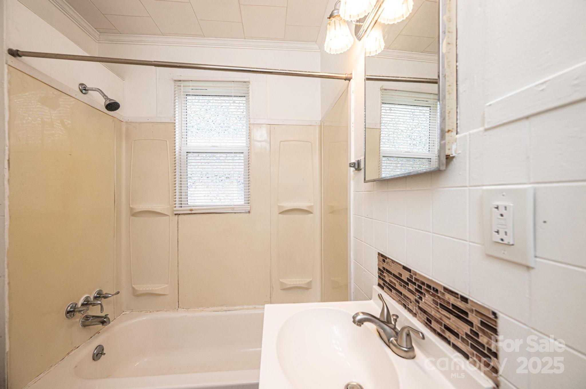 504 North Spring Avenue Newton, NC 28658 - Photo 29 of 35 a bathroom with a bathtub and a shower