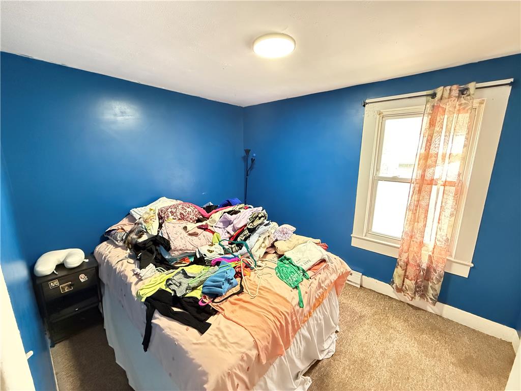 700 Philo Street Scranton, PA 18508 - Photo 15 of 19 A well-lit bedroom features plush carpeting and ample natural light from a single window.