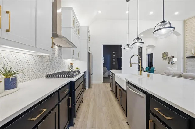 a kitchen with lots of counter space and wooden floor