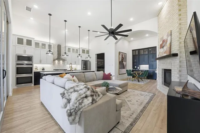 a living room with fireplace furniture and a wooden floor