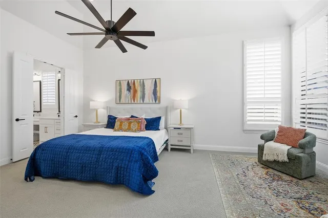 a bedroom with a bed a couch and a window