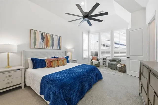 a bedroom with a bed a large bed and a large window