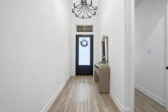 a view of hallway with wooden floor