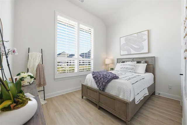 a bedroom with bed and window