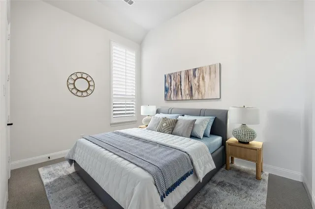 a bedroom with a large bed and a window