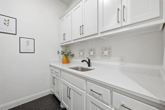 a kitchen with a sink and cabinets