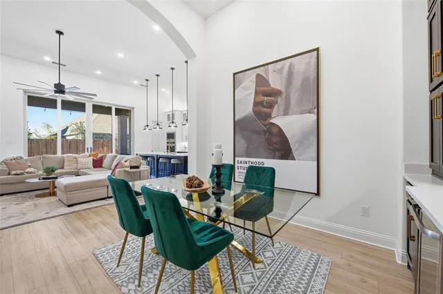 a living room with furniture a rug and a painting