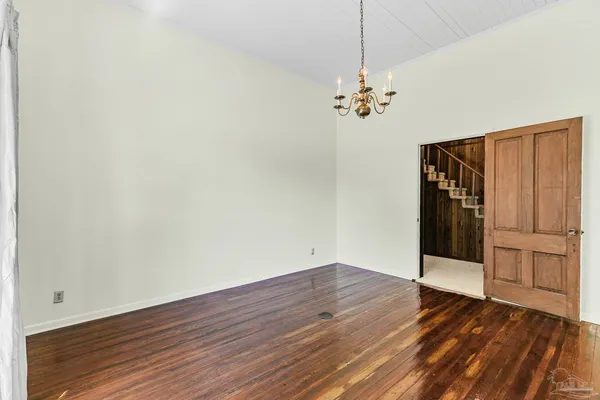 a kitchen with granite countertop a sink a window and cabinets