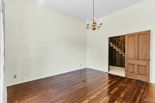 a kitchen with granite countertop a sink a window and cabinets
