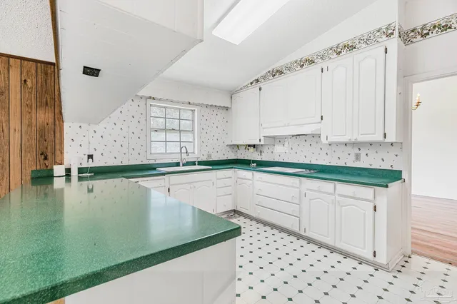 a kitchen with a sink and cabinets