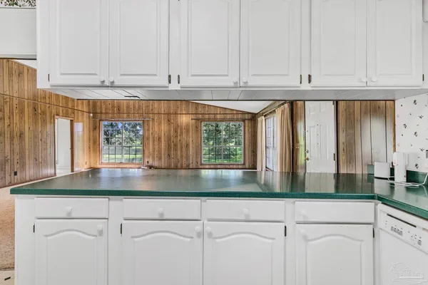 a view of a entrance and room with wooden floor