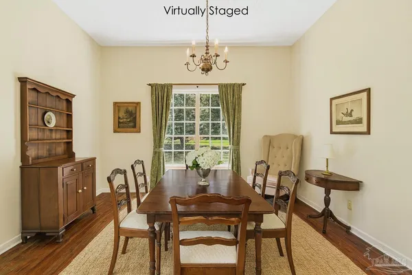 a view of a dining room with furniture window and wooden floor