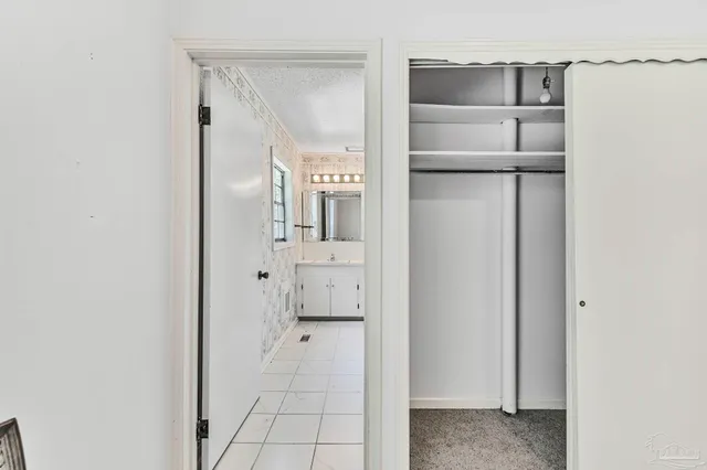 an aerial view of a houses with outdoor space and trees all around