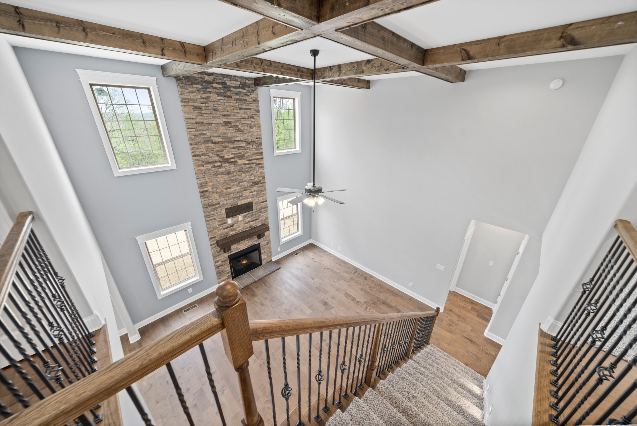 267 Alonzo Place Cunningham, TN 37052 - Photo 25 of 40 a view of a hallway to a livingroom with wooden floor a fireplace and windows