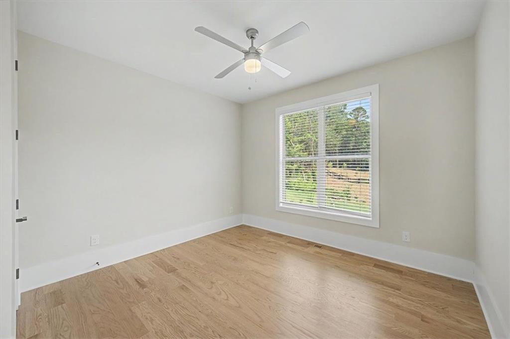 217 Laura Lake Road Marietta, GA 30066 - Photo 28 of 54 an empty room with chandelier fan and windows