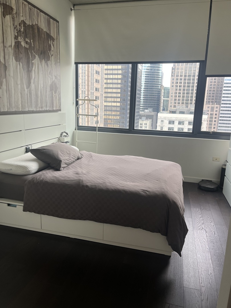 235 West Van Buren Street, Unit 2415 Chicago, IL 60607 - Photo 12 of 19 a bedroom with a bed and window