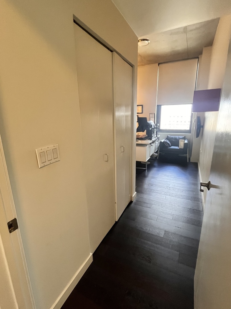 235 West Van Buren Street, Unit 2415 Chicago, IL 60607 - Photo 13 of 19 a view of hallway with a couch and a window
