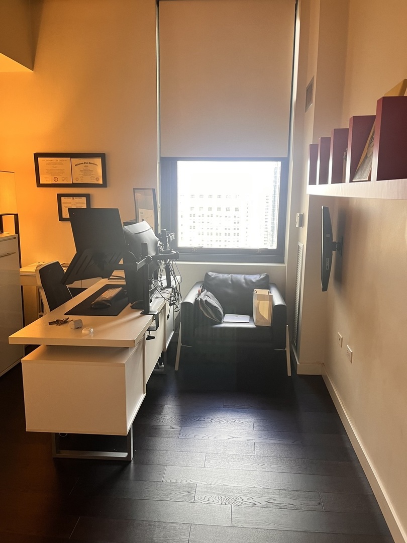 235 West Van Buren Street, Unit 2415 Chicago, IL 60607 - Photo 15 of 19 a living room with furniture and a window