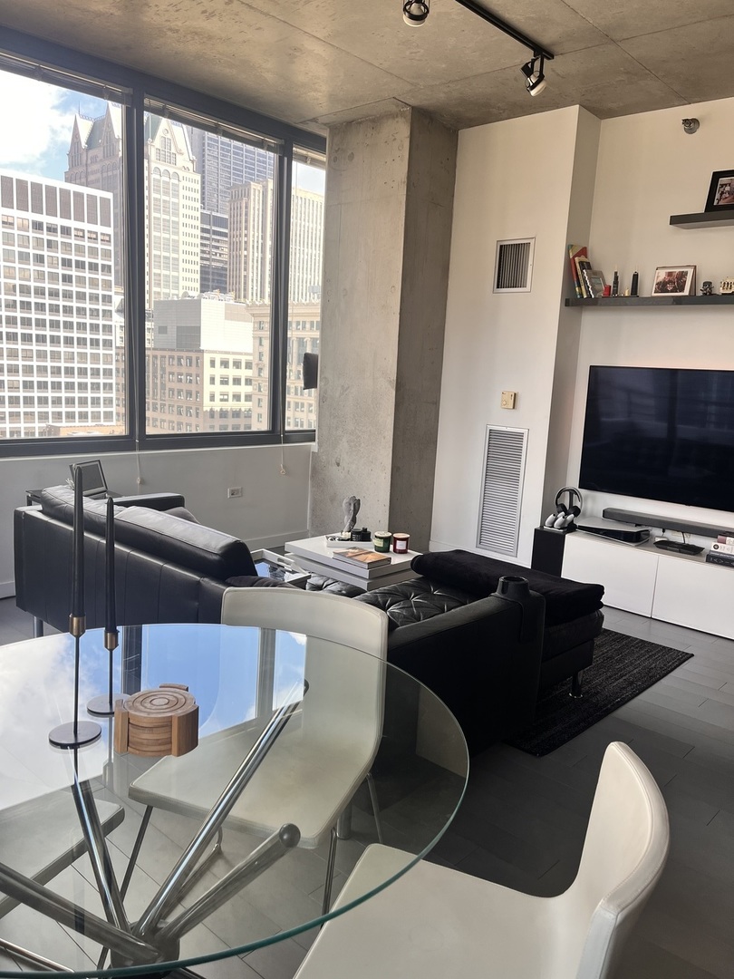 235 West Van Buren Street, Unit 2415 Chicago, IL 60607 - Photo 6 of 19 a kitchen with a table chairs and a stove