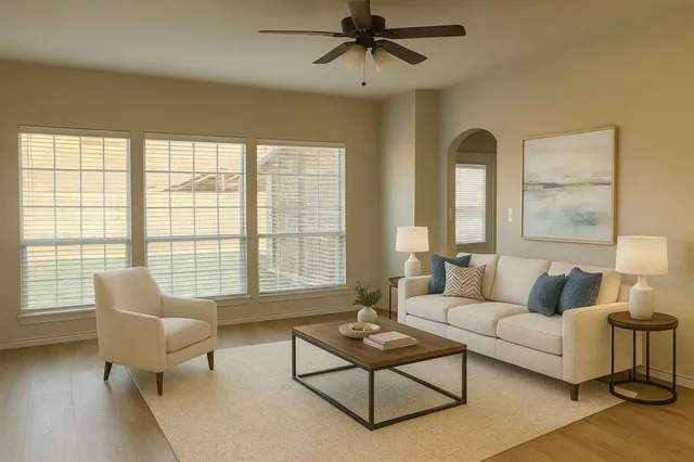 a living room with furniture and a floor to ceiling window