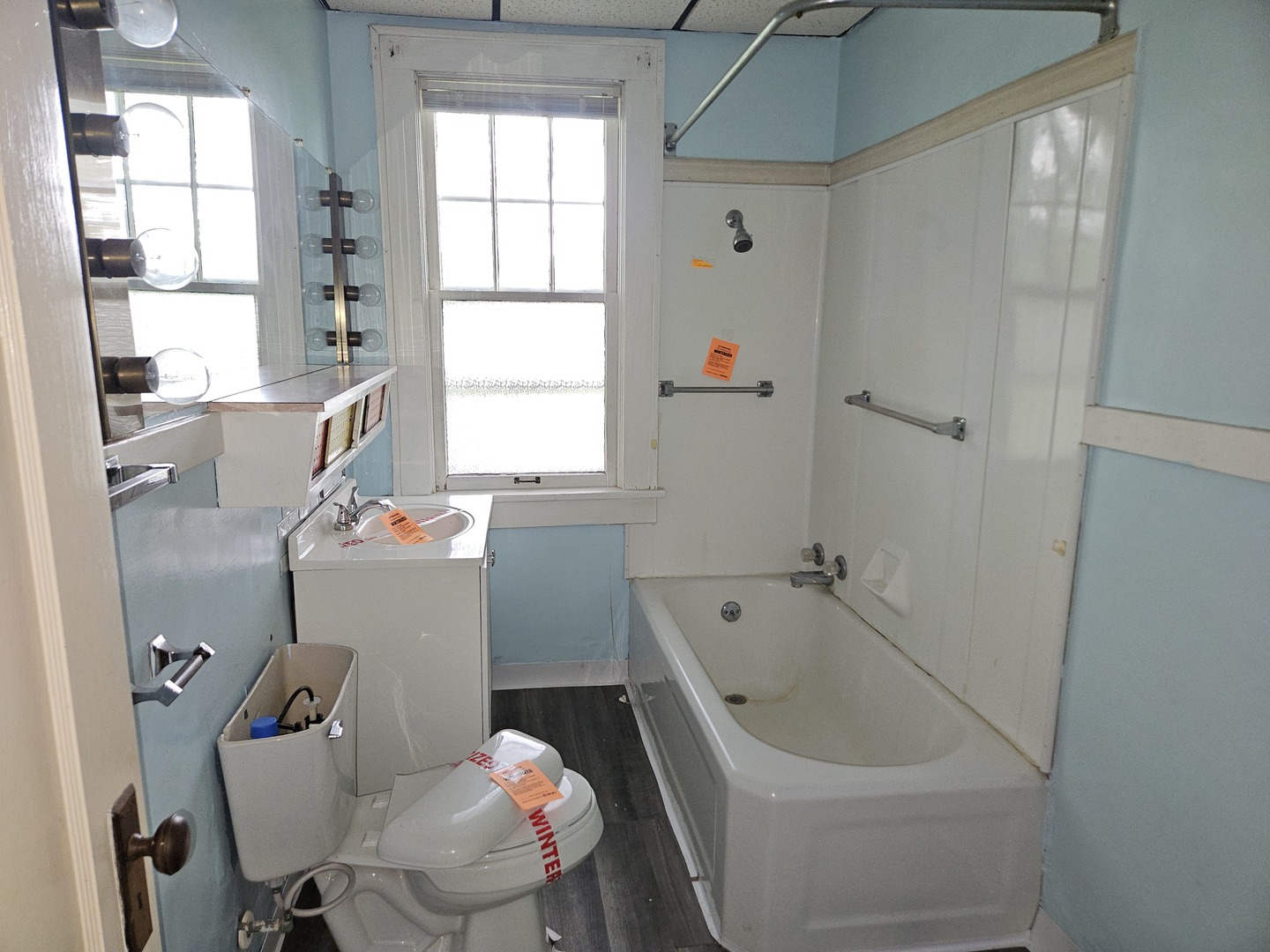 402 East 5th Street Flora, IL 62839 - Photo 18 of 29 a bathroom with a tub sink and window