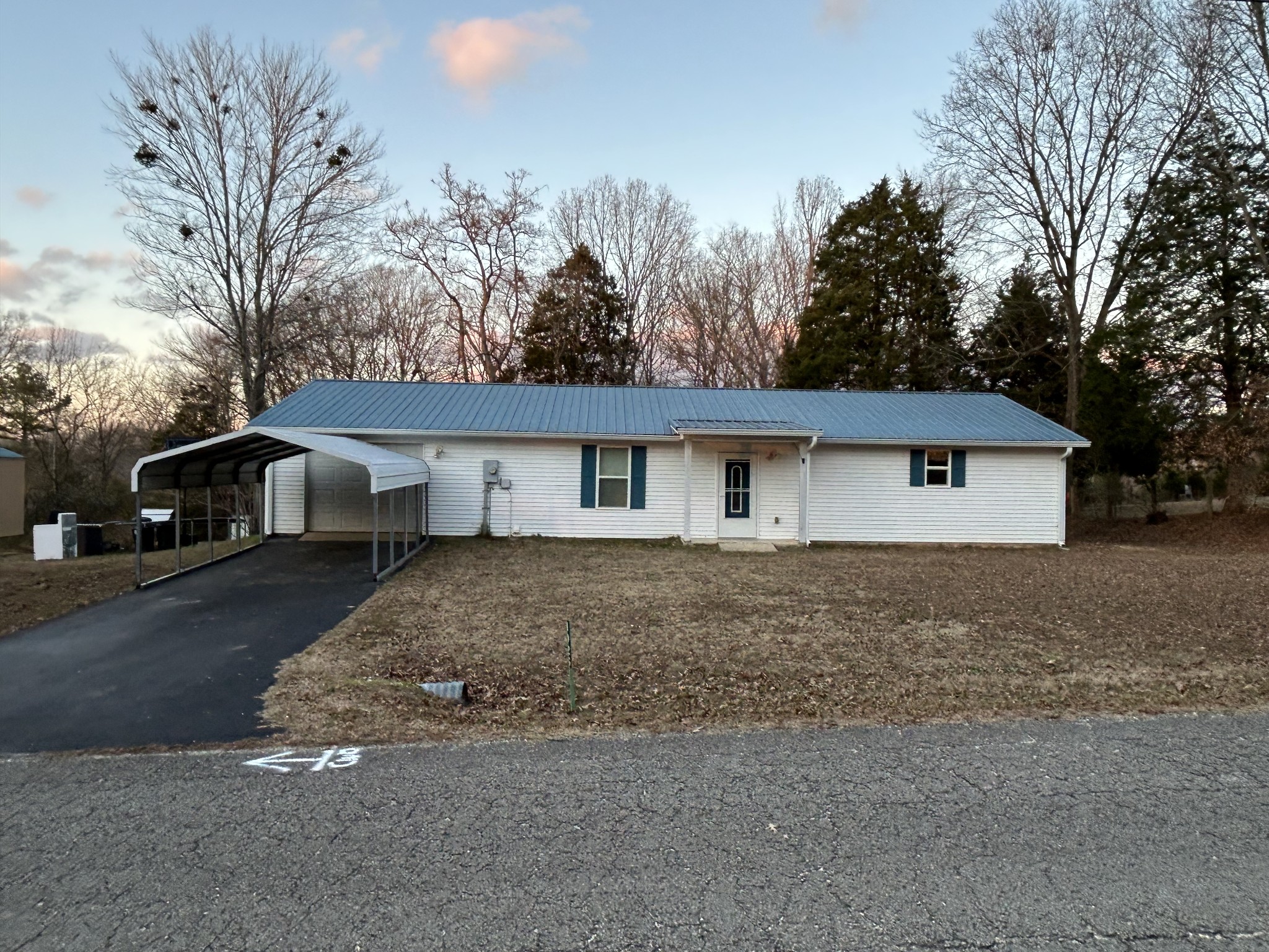 a front view of house with yard and trees