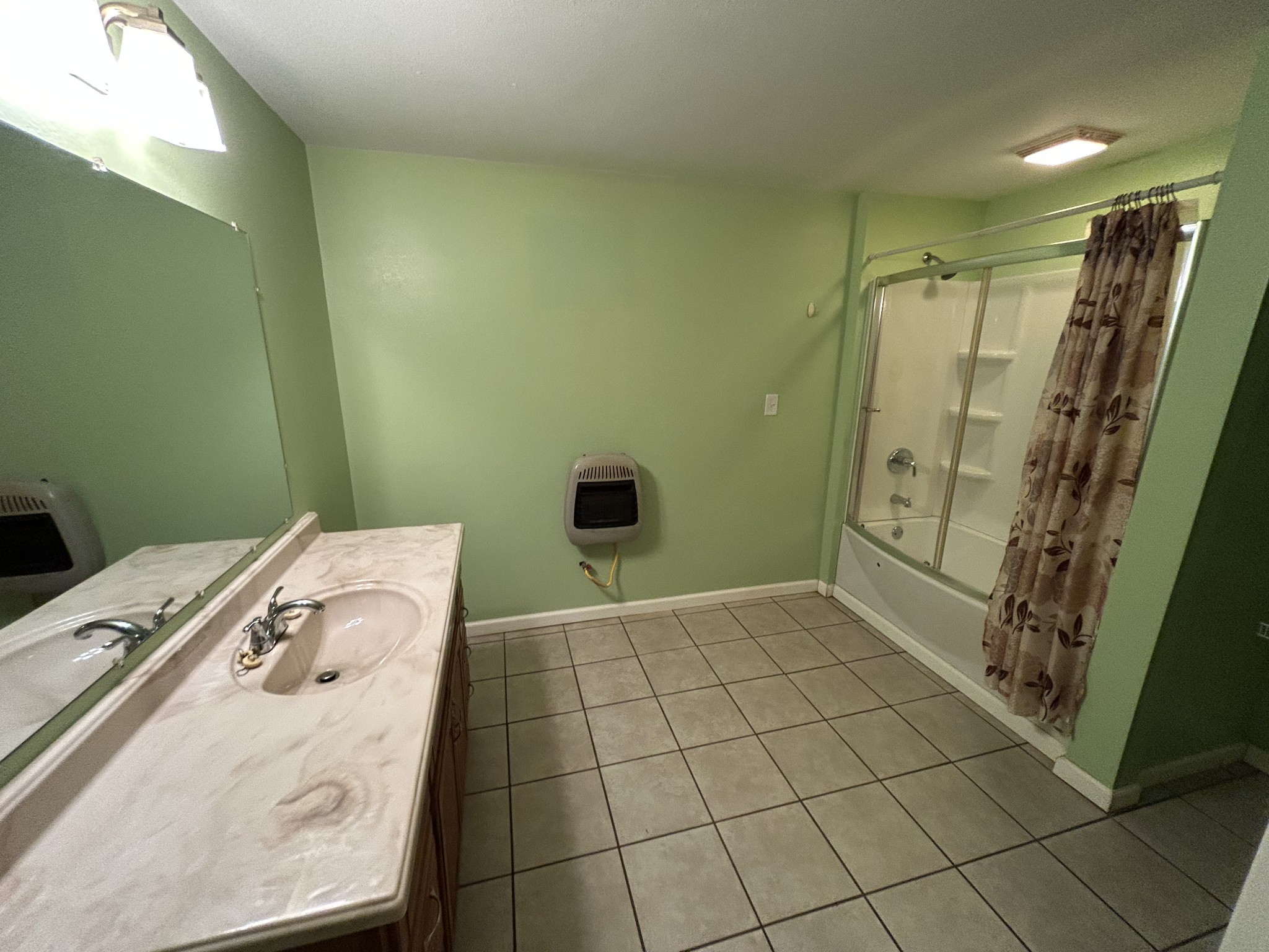 1026 Tom White Road Big Sandy, TN 38221 - Photo 11 of 19 a bathroom with a sink a toilet and shower