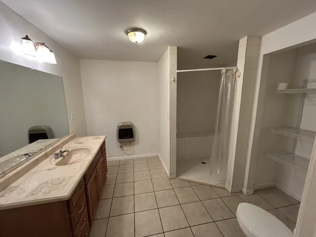 a bathroom with a sink toilet and shower