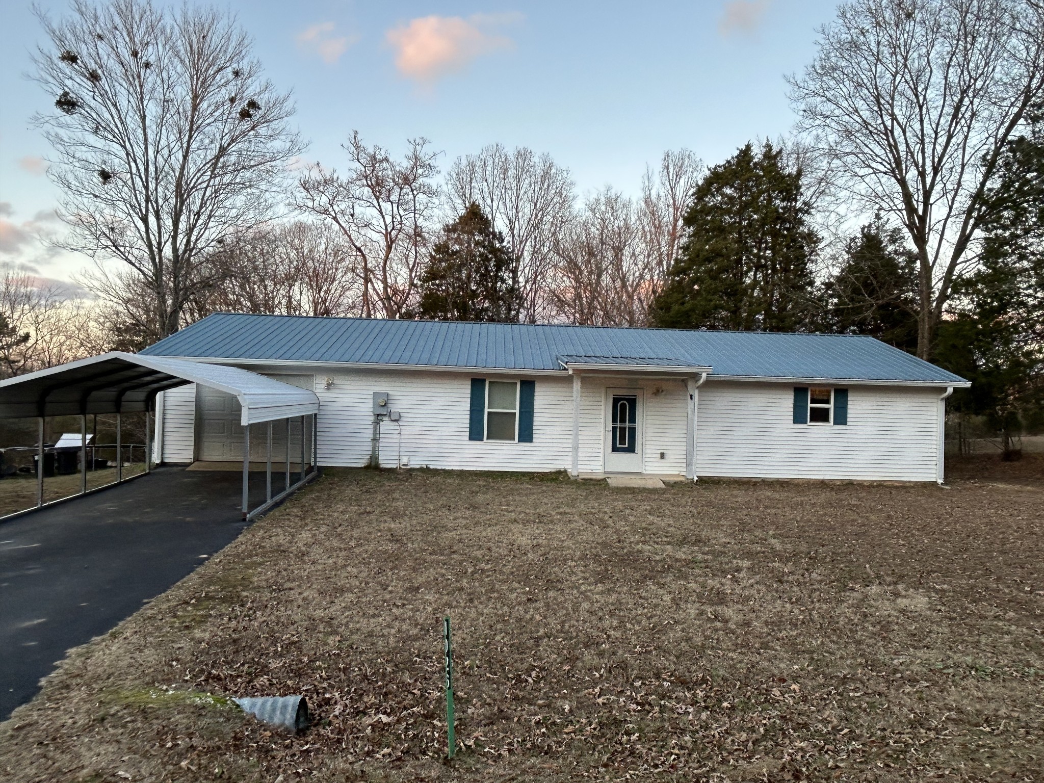 1026 Tom White Road Big Sandy, TN 38221 - Photo 2 of 19 a house that has a tree in front of it