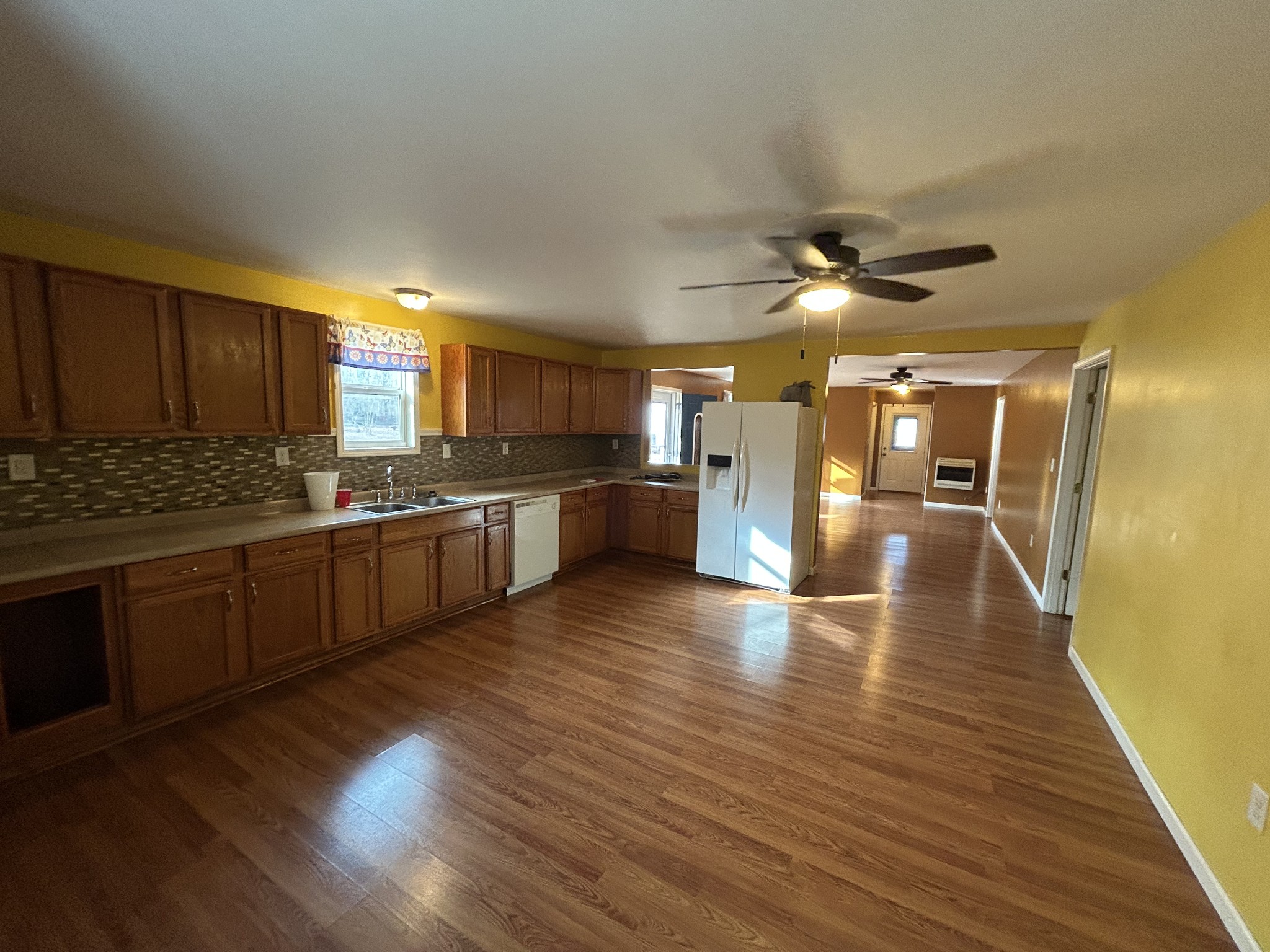 1026 Tom White Road Big Sandy, TN 38221 - Photo 5 of 19 a kitchen with stainless steel appliances granite countertop a stove cabinets and wooden floor