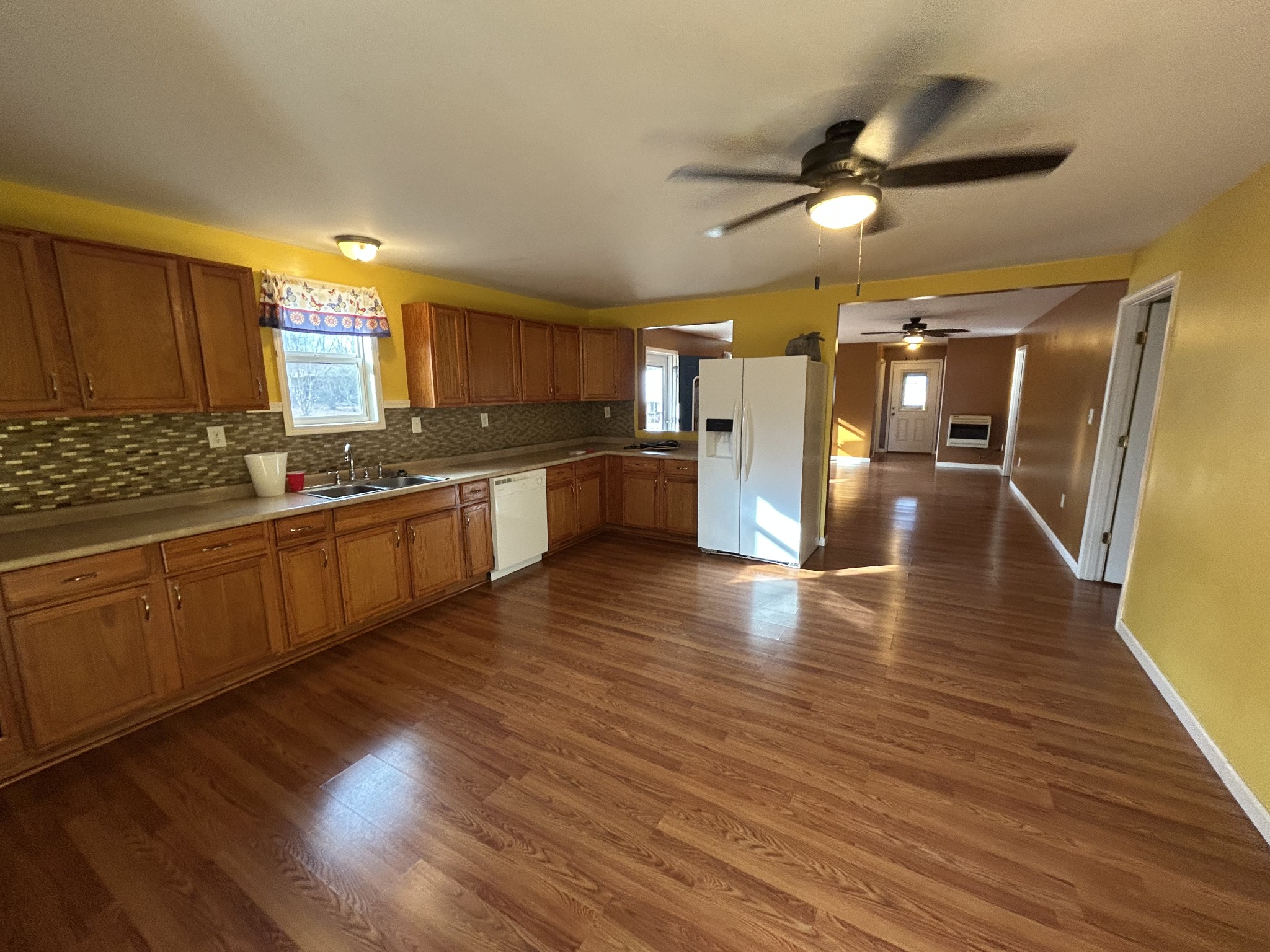 1026 Tom White Road Big Sandy, TN 38221 - Photo 6 of 19 a large kitchen with stainless steel appliances granite countertop a lot of counter space and wooden floors