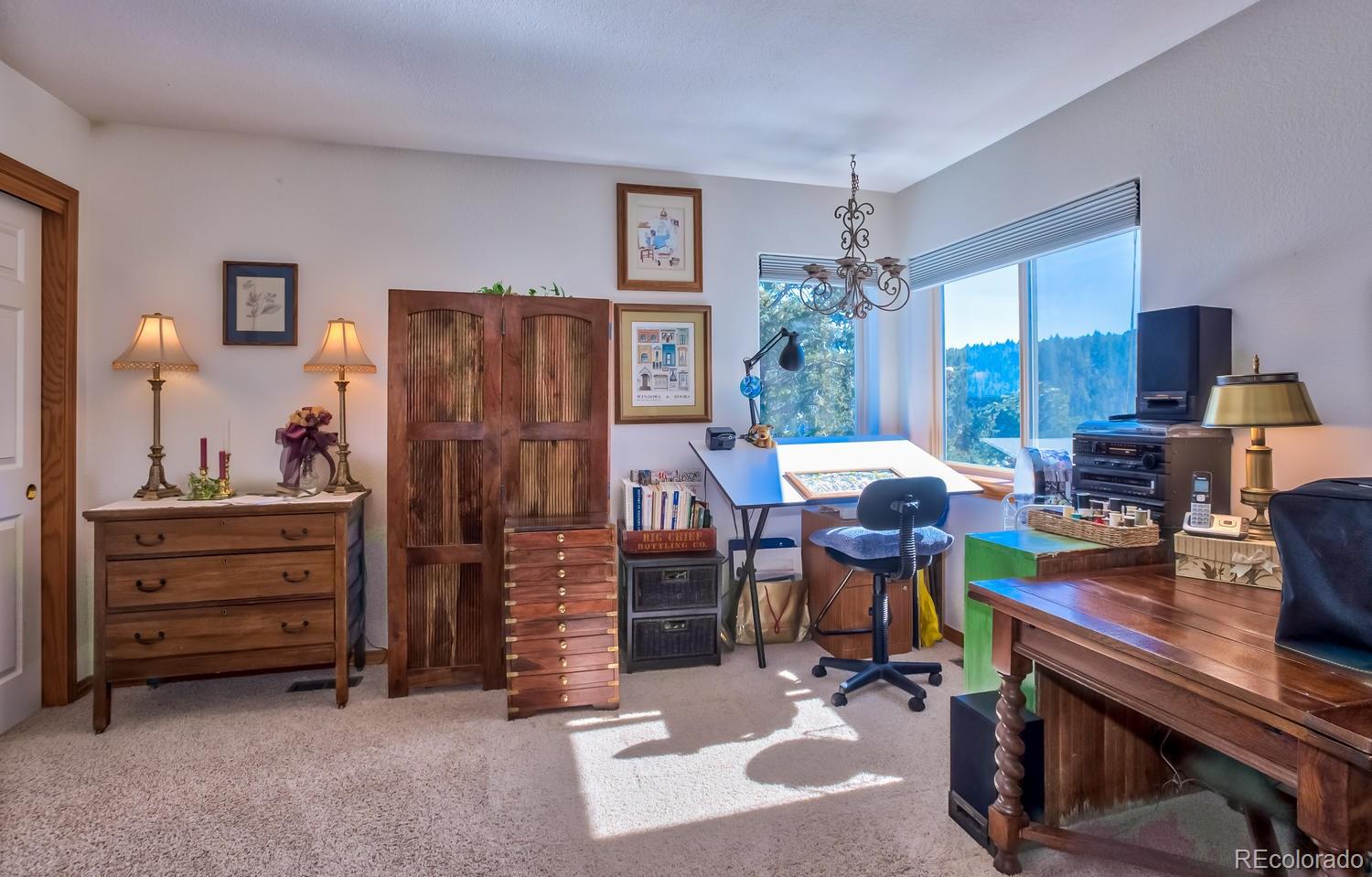 29323 Gray Hawk Drive Evergreen, CO 80439 - Photo 18 of 31 a view of a workspace with furniture and chandelier