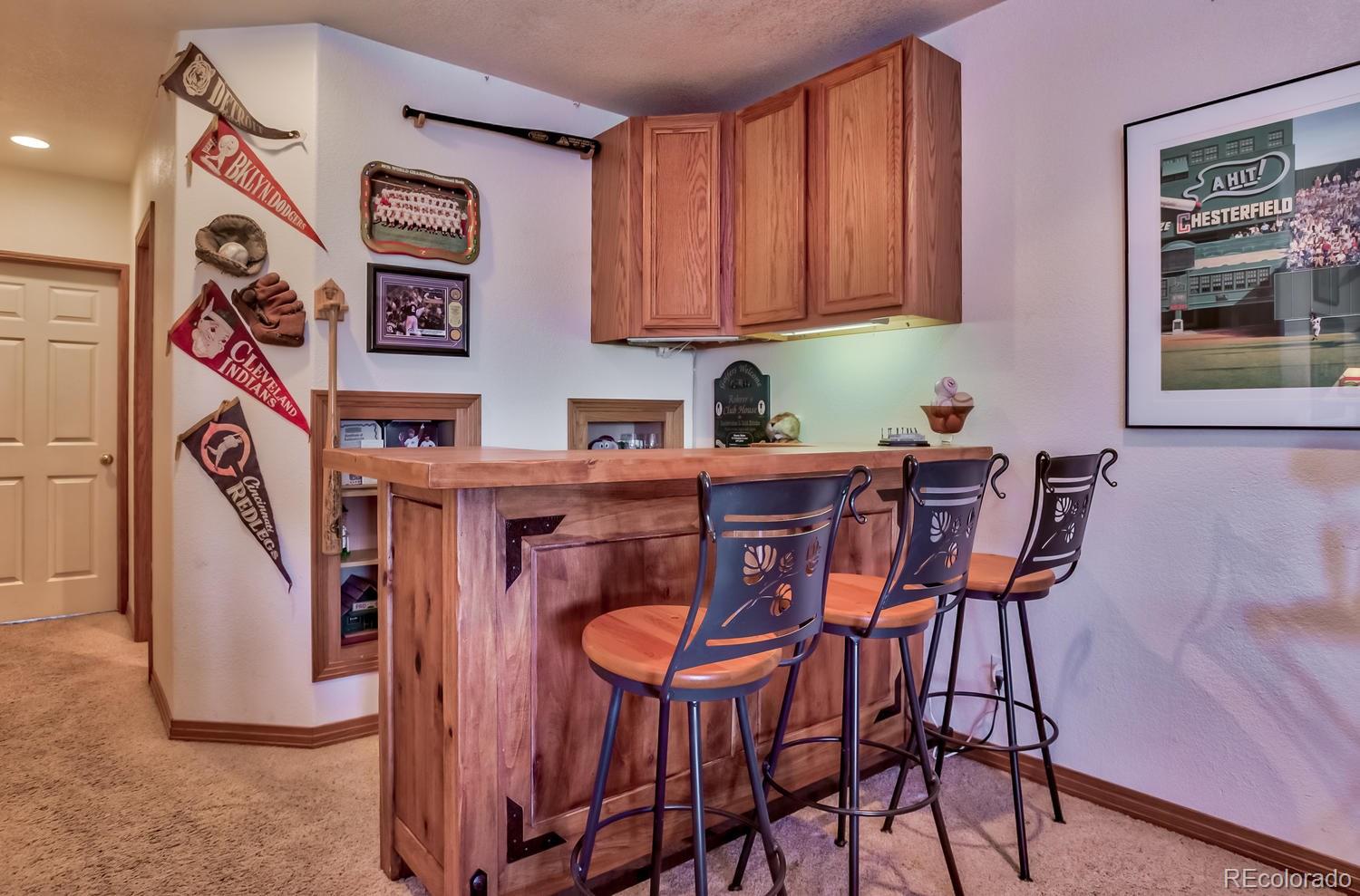 29323 Gray Hawk Drive Evergreen, CO 80439 - Photo 22 of 31 a kitchen with stainless steel appliances a table chairs and a refrigerator