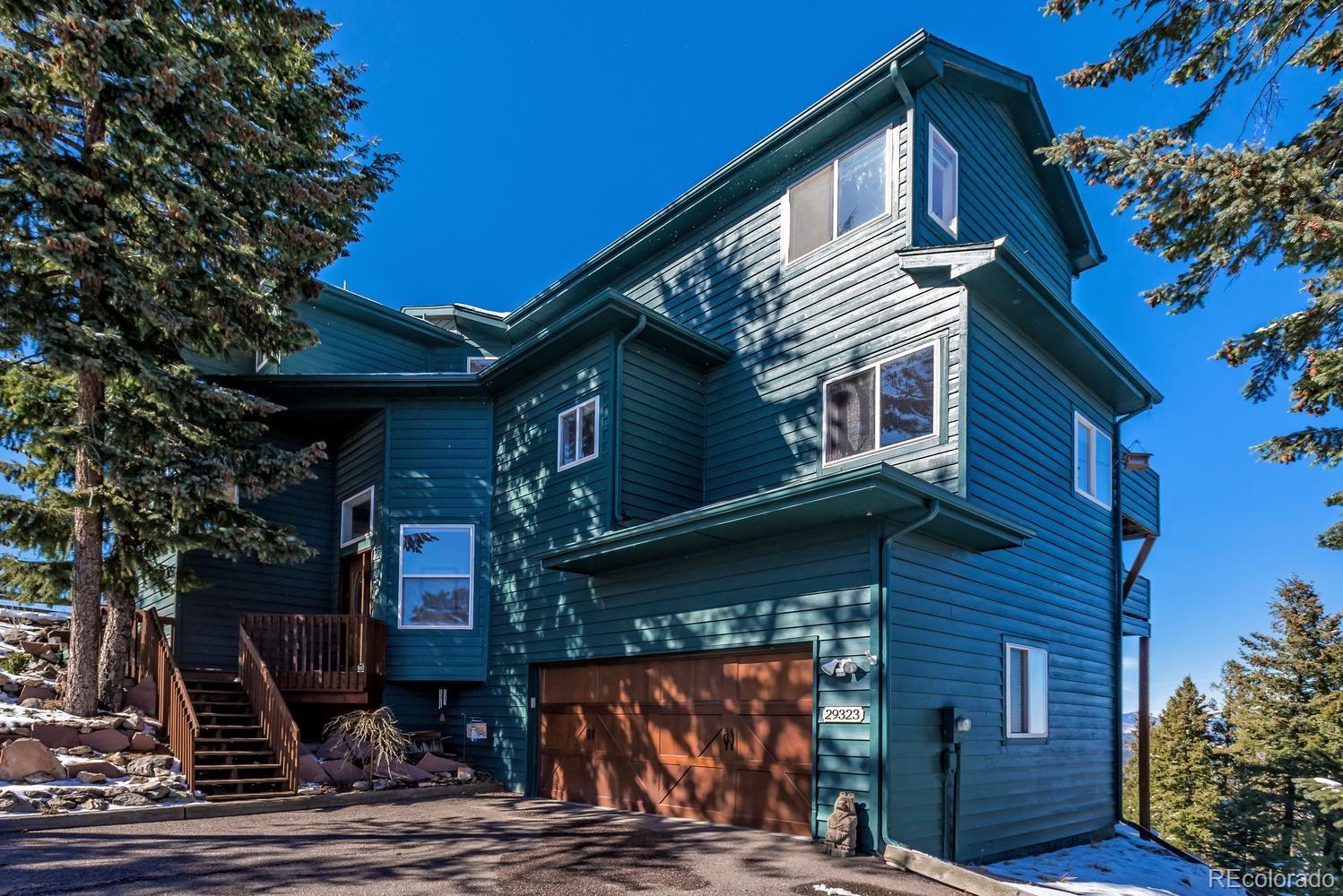 29323 Gray Hawk Drive Evergreen, CO 80439 - Photo 26 of 31 a front view of a house with garden